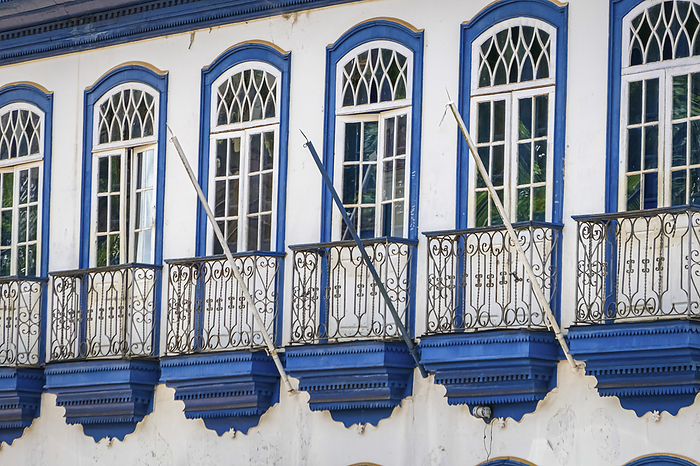 Close up of historic house facade with windows and balustrades in white and blue, Serro, Minas Gerai Close up of historic house facade with windows and balustrades in white and blue, Serro, Minas Gerai, by Zoonar Uwe Bergwitz