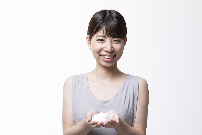 Beauty image of a young bare skinned Japanese woman with soapy lather (People)
