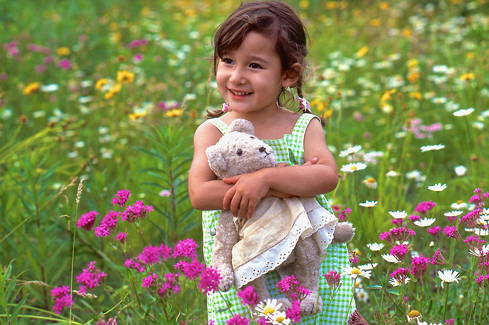 Playing in a flower garden in early summer