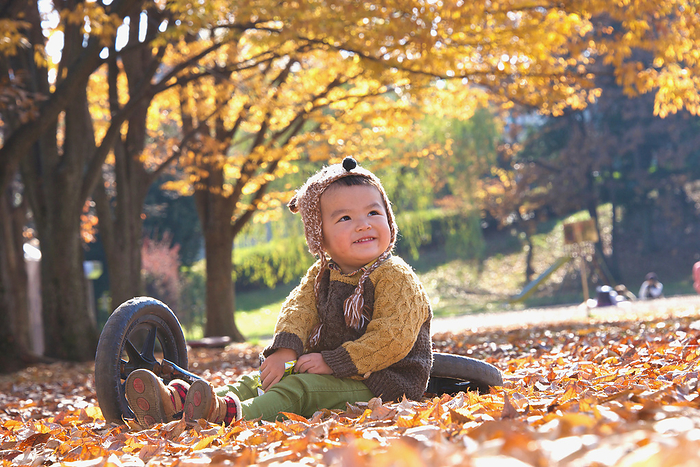 Playing among the dead autumn leaves