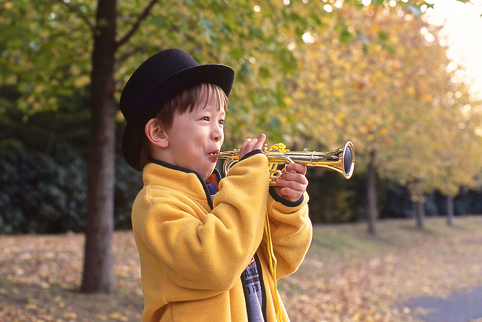 A child blowing a toy trumpet