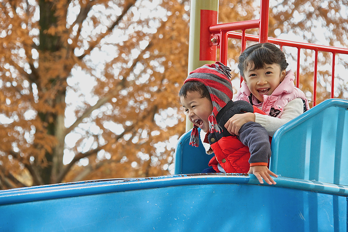 Children playing in a park in autumn