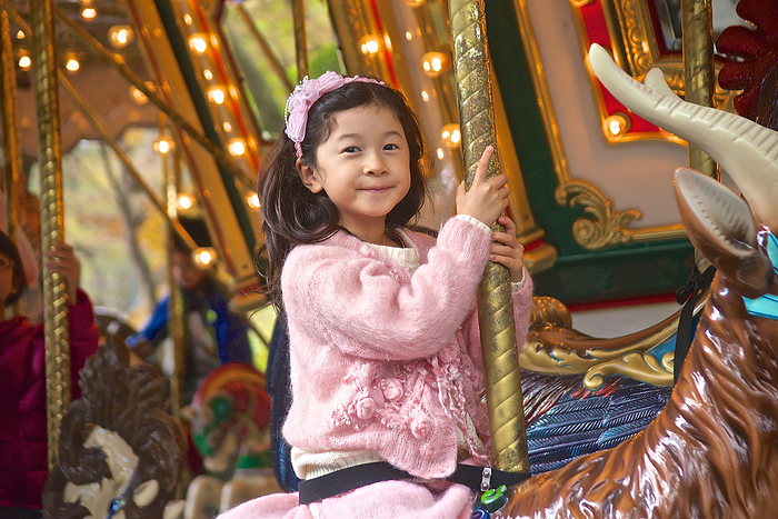 Girl riding on merry-go-round