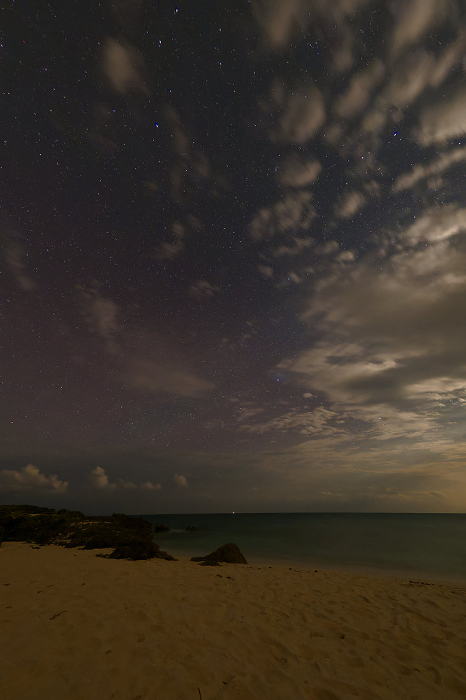 Sandy beach and star-filled sky at night