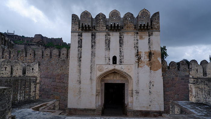 Tourists at Bala Hissar Gate or Darwaza, the main entrance to Golconda fort. The spandrels have yalis and decorated roundels, by Zoonar/RealityImages