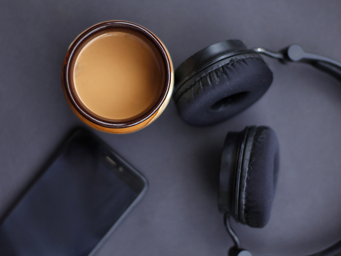 Top view of tea or chai with headphones and phone. Tea time, India Top view of tea or chai with headphones and phone. Tea time, India, by Zoonar RealityImages