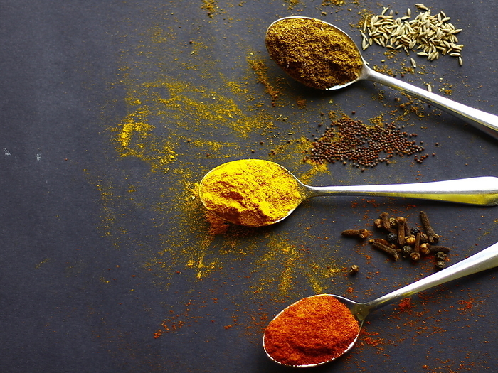 Indian spices, Garam masala, Red chilli powder and saffron powder on spoons, mustard seeds, aniseed and cloves on dark background Indian spices, Garam masala, Red chilli powder and saffron powder on spoons, mustard seeds, aniseed and cloves on dark background, by Zoonar RealityImages