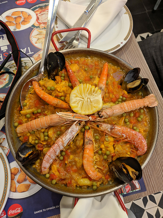 Paella with chicken, shrimps, prawns, oysters, squids, octopus Paella with chicken, shrimps, prawns, oysters, squids, octopus, by Zoonar RealityImages