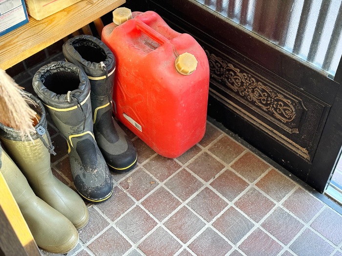 Entranceway with boots and polyethylene tanks.