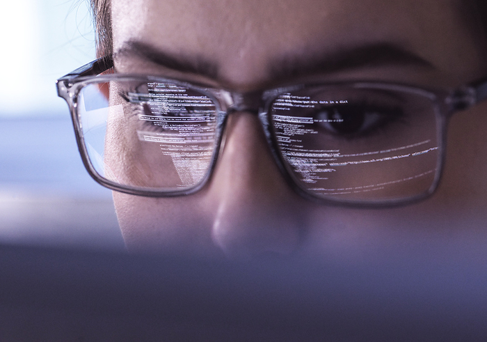 Reflection of encrypted data on IT professional's eyeglasses
