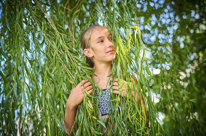 Girl holding leaves of willow tree