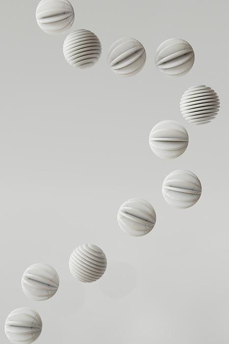3D render of striped spheres floating against white background