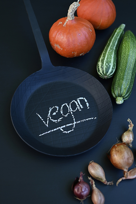 decoration for the kitchen Studio shot of vegetables and black frying pan with word vegan written in chalk