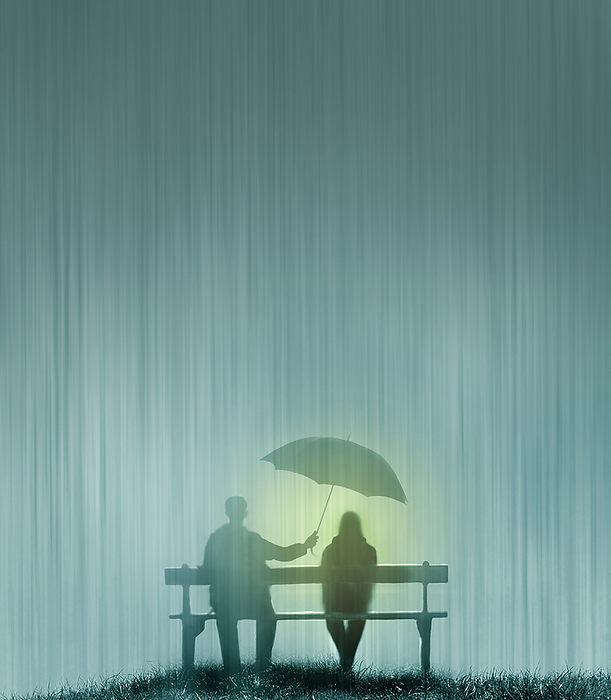 Couple sitting on bench during heavy rain