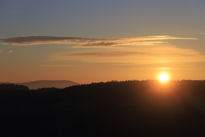 Germany Germany, Saxony, Sun setting over forest in Saxon Switzerland
