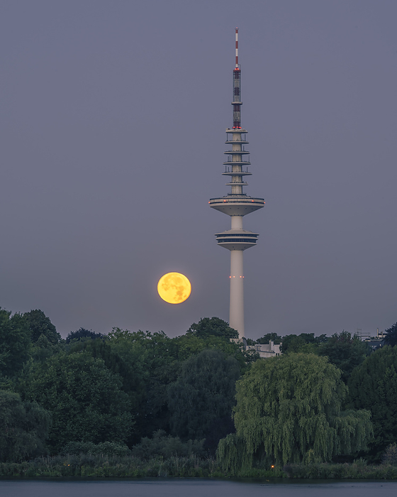 Hamburg, Germany Germany, Hamburg, Full moon rising over communications tower at dusk