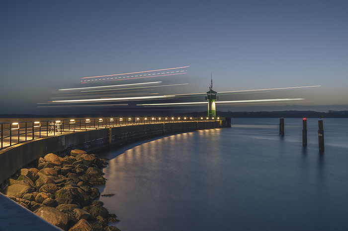 L beck, Germany Germany, Schleswig Holstein, Lubeck, Blurred motion of ship passing Travemunde lighthouse at dawn