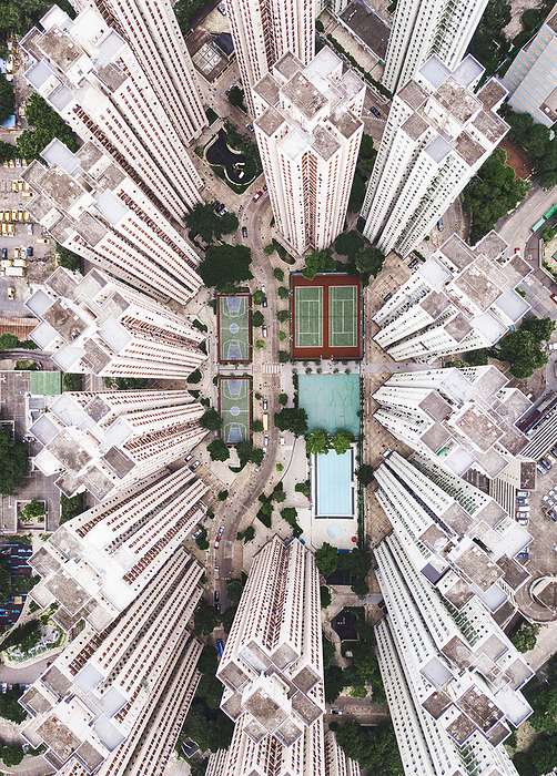 Aerial view of Hong Kong Swimming pool with sports courts near tall buildings in Hong Kong city