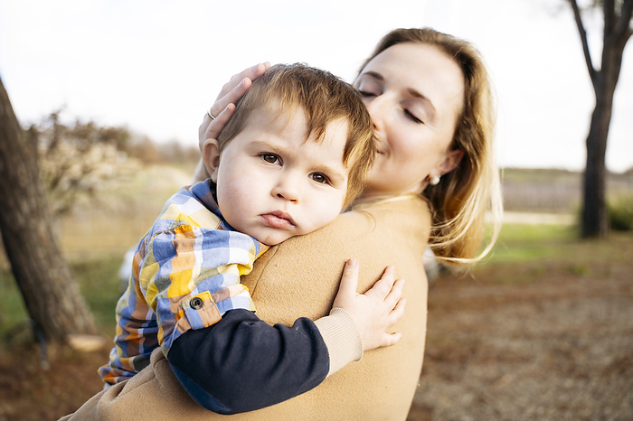 Woman embracing son in arms