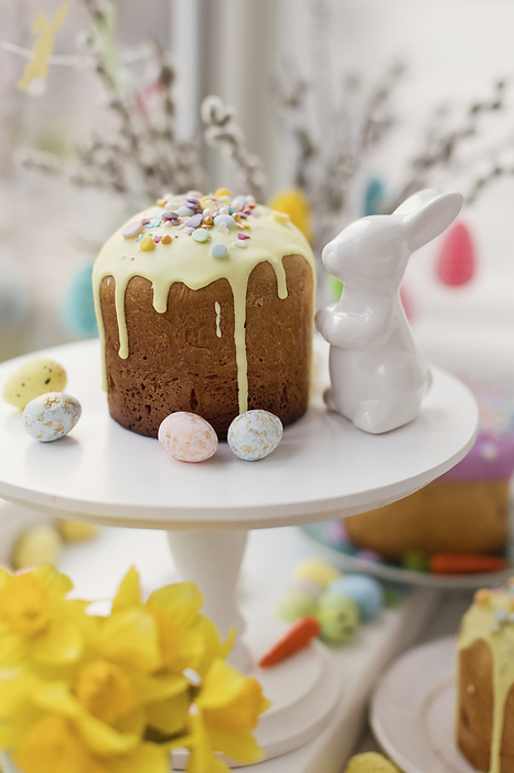 Cake decorated with sugar sprinkles near Easter bunny toy