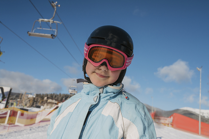 Girl wearing ski goggles at resort