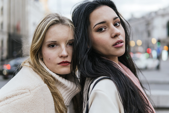 Multiracial young women with black and blond hair in city
