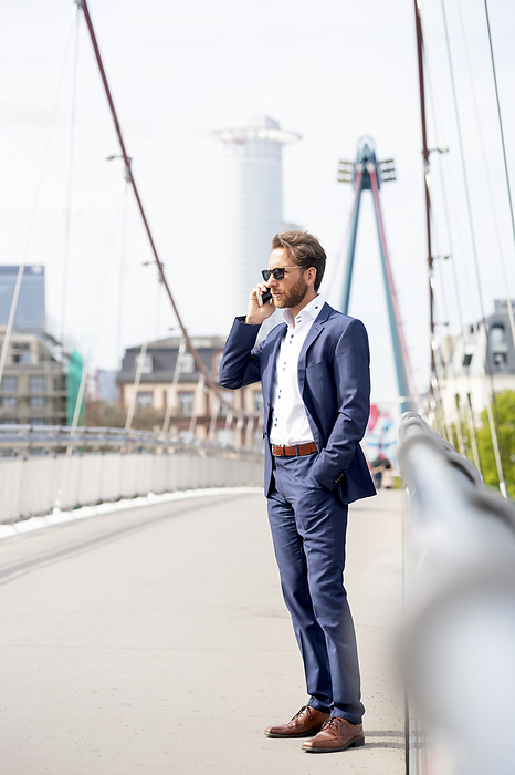 Businessman talking on smart phone in city