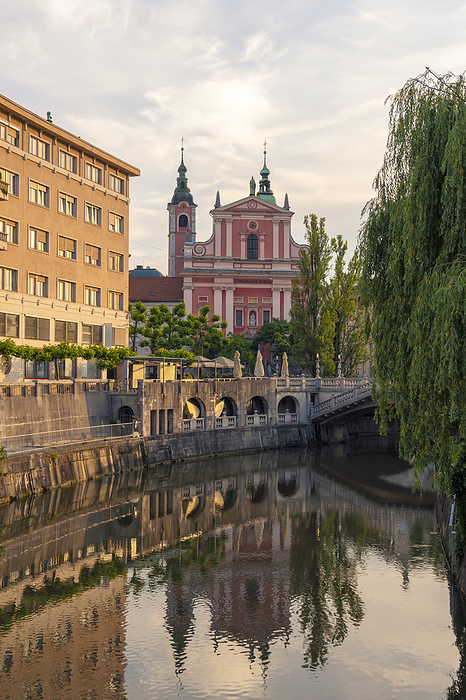 Ljubljana, Slovenia Slovenia, Ljubljana, Triple Bridge at dusk with Franciscan Church of Annunciation in background