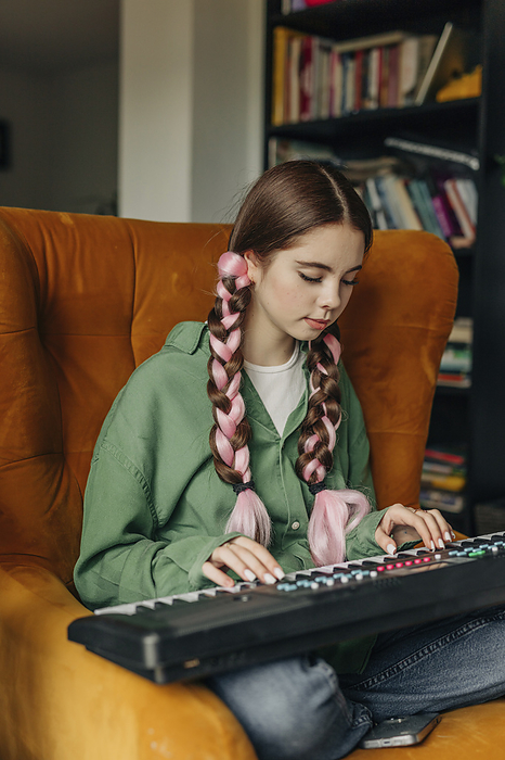 Young woman playing piano at home