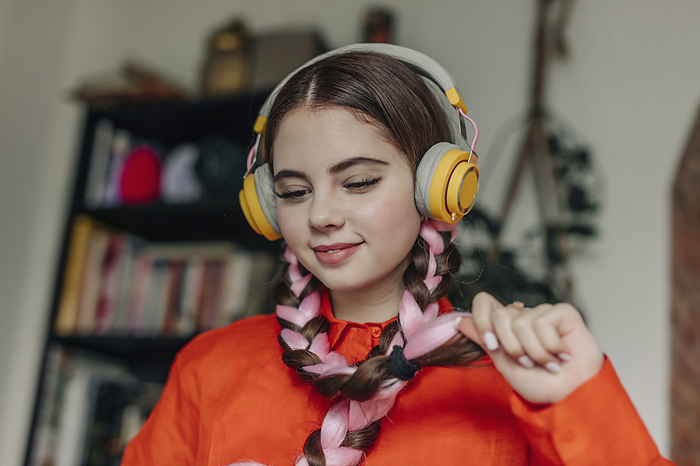 Happy young woman wearing wireless headphones