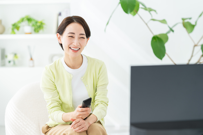 Middle Japanese woman watching TV.