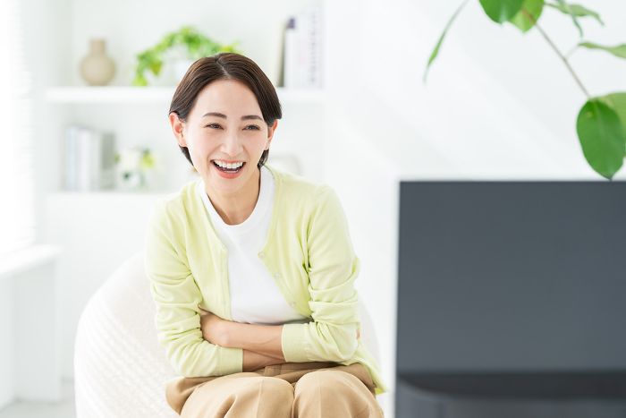 Middle Japanese woman watching TV.