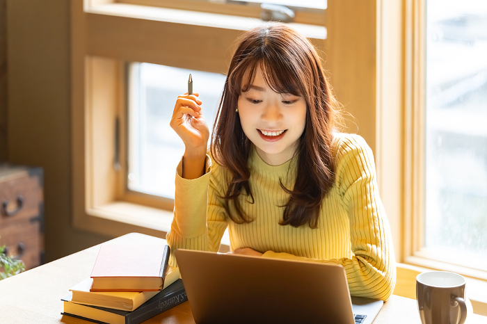 Smiling Japanese woman using a laptop computer (People)