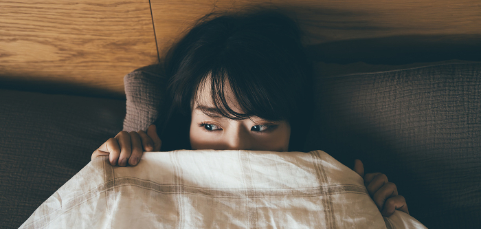 Japanese woman in bed thinking (People)