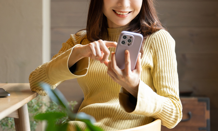 Smiling Japanese woman using a smartphone (People)