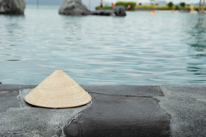 Traditional Vietnamese conical hat placed by the pool Nong La