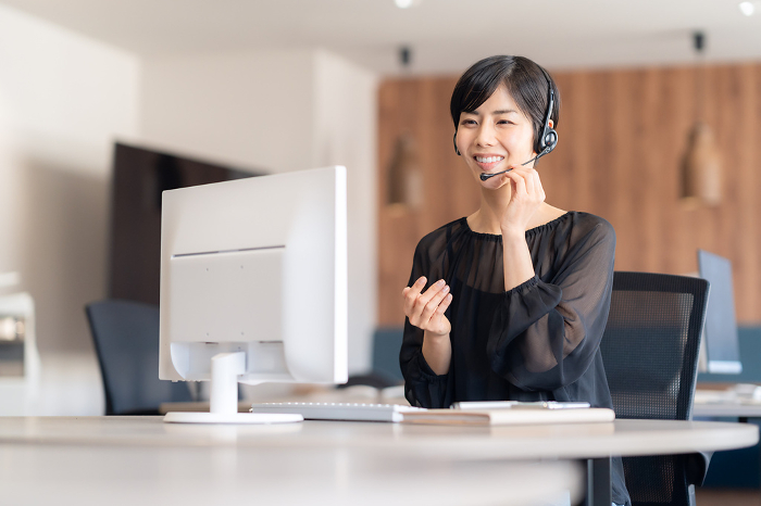 Young Japanese woman having an online meeting in her office (People)