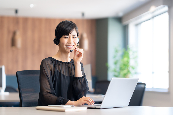 Young Japanese woman having an online meeting in her office (People)