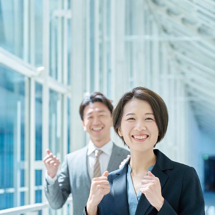 Japanese men and women in suits smiling and cheering (People)