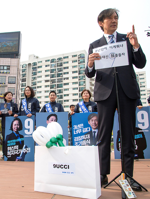 2024 South Korea General Election: The Rebuilding Korea Party Cho Kuk, April 6, 2024 : Cho Kuk, leader of the Rebuilding Korea Party  aka the Korea Innovation Party  for proportional representation seats, holds a sign which a supporter prepared at the party s meeting with supporters in Seoul, South Korea, ahead of the April 10 general elections. The sign reads,  What the hell in two years  after President Yoon Suk Yeol s inauguration . Cast a vote instead of a stone . Mock green onions in a mock Gucci bag which a supporter prepared for Cho s birthday celebration are seen. The mock green onions makes a parody of South Korean President Yoon Suk Yeol who aroused anger by finding the price tag of 875 won   0.65  for a bunch of green onions a  reasonable price  at a grocery mall last month. The 875 won   0.65  was a temporary discount price offered due to a government subsidy and the average retail prices of green onions was about 3,000 to 4,000 won   2.2 to 2.9  for weeks, which was some of the highest levels over the years. The signs on a mock Gucci bag read,  Rather than Dior... Vote for 9  the electoral symbol of the Rebuilding Korea Party  . The symbol of  9UCCI  is pronounced in Korean similarly to Gucci, luxury fashion brand, as  9  is pronounced as  Gu . The sign makes a parody of a scandal of South Korea s first lady Kim Keon Hee who received a luxury Dior bag as a  gift  in 2022. Cho Kuk, South Korea s former Justice Minister under the previous liberal Moon Jae In administration, was an architect of the liberal government s prosecution reform.  Photo by Lee Jae Won AFLO 