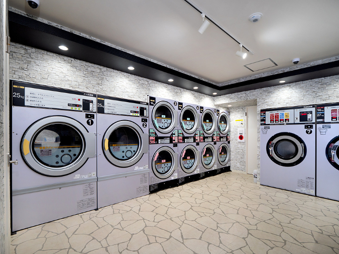 Coin-operated laundromat with a row of large washing machines