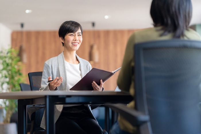 A young Japanese woman having a business meeting in an office (People)