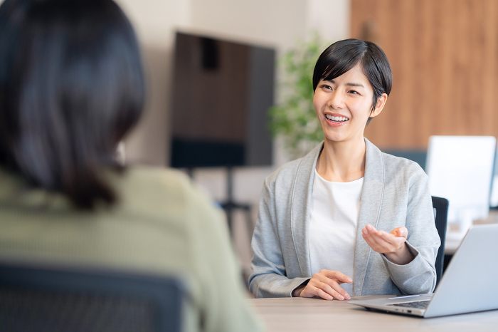A young Japanese woman having a business meeting in an office (People)