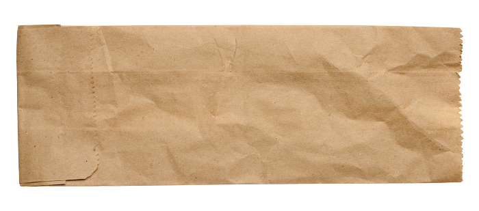 Brown kraft paper bag for packaging products in stores on an isolated background, top view Brown kraft paper bag for packaging products in stores on an isolated background, top view