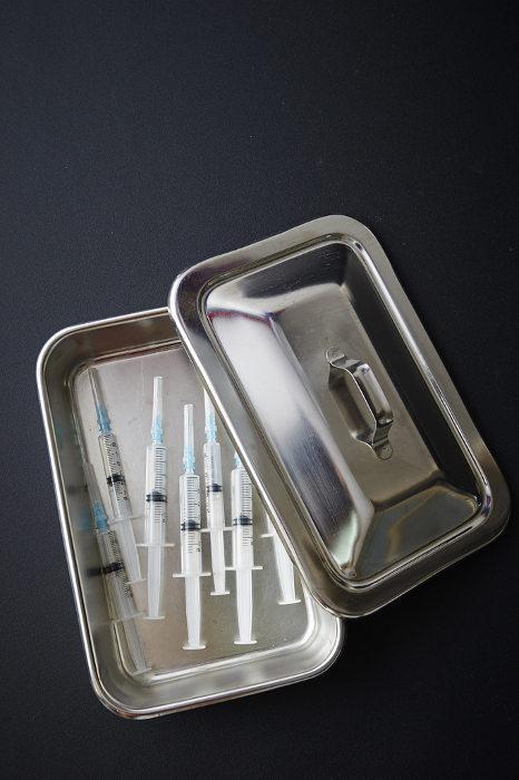 Syringe in stainless steel container