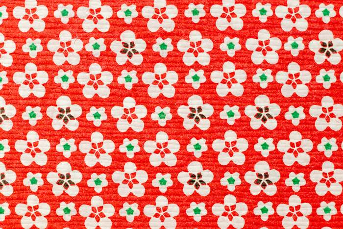 Japanese pattern of white plum blossoms on red ground