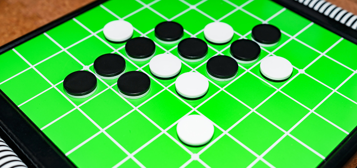 Othello is a form of British Reversi [image of Othello game].