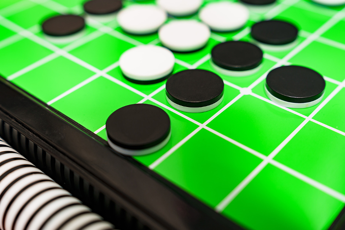 Othello is a form of British Reversi [image of Othello game].