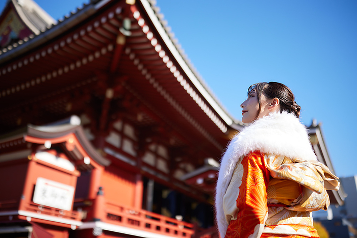 Japanese woman in furisode kimono looking into the distance