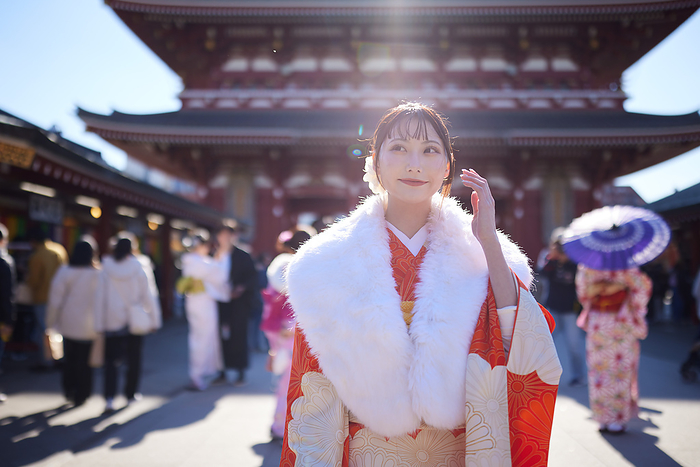 Japanese woman in furisode kimono looking into the distance